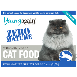 A gray, long-haired cat sits next to a package labeled Young Again Pet Food Zero Mature Trucarnivore Cat Food, Zero Mature Health Formula 54/24. Text highlights it as high protein and for a carnivore diet.